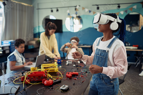 Fotografija Portrait of young black girl using VR technology in engineering class, copy spac