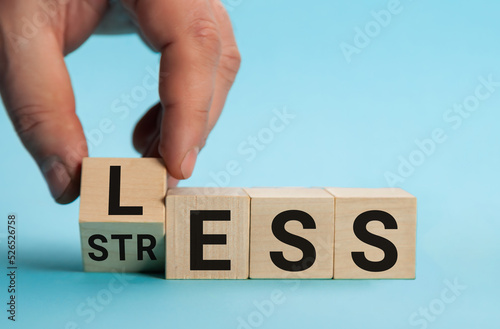 Having less stress or being stress-less. The word on wooden cubes. The concept of having less stress or being stress-less in letters. Business and psychological