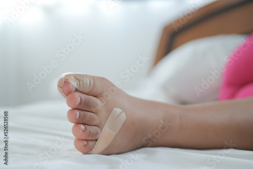 adhesive bandage on child feet on bed 