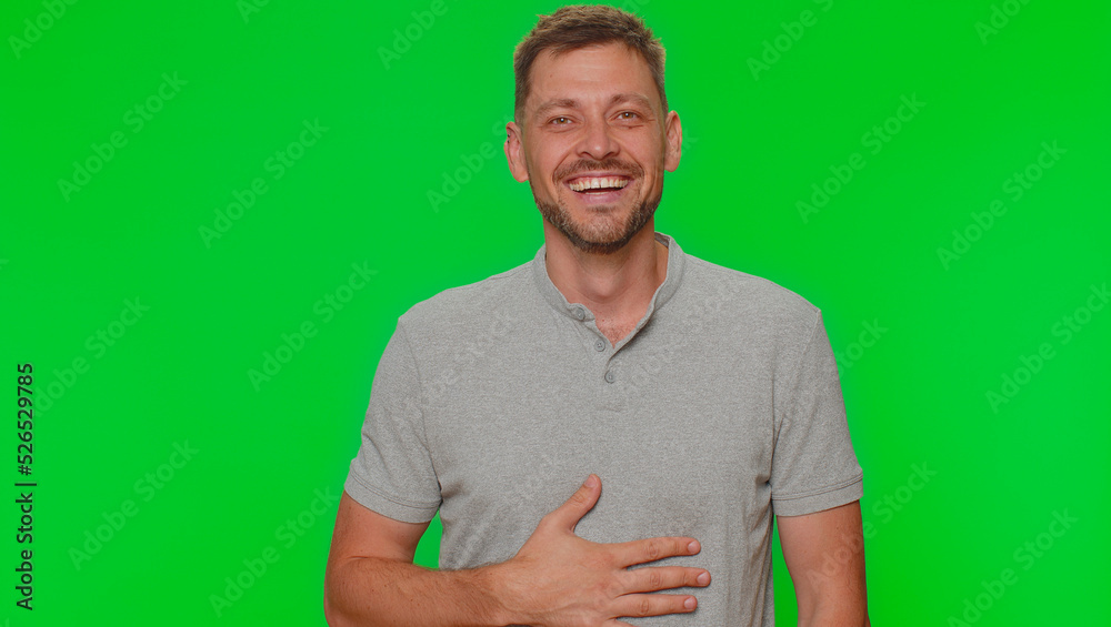 Bearded young man laughing out loud after hearing ridiculous anecdote, funny joke, feeling carefree amused, positive people lifestyle. Adult guy isolated on green chroma key studio background indoors Bearded young man laughing out loud after hearing ridiculous anecdote, funny joke, feeling carefree amused, positive people lifestyle. Adult guy isolated on green chroma key studio background indoors