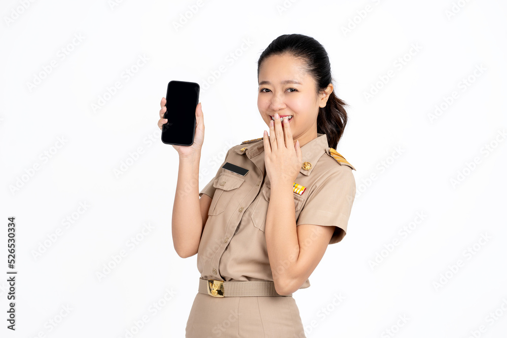 Portrait of Asian businesswoman in cream Thai government uniform is showing or presenting mobile phone application isolated over white background Portrait of Asian businesswoman in cream Thai government uniform is showing or presenting mobile phone application isolated over white background