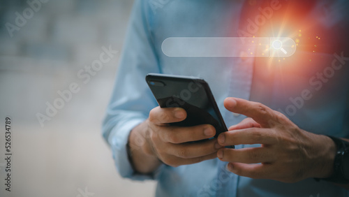 Fototapeta Naklejka Na Ścianę i Meble -  search technology Search Engine Optimization A man uses his smart phone to search for information. by using the search engine bar functionality on your website.