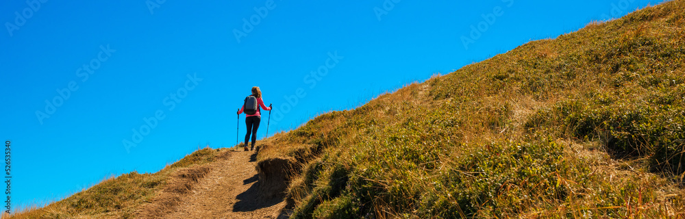 Athletic woman hiking mountain in France