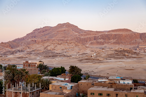 Aerial view of Valley of The Kings in Theban Necropolis in the morning with a village and Temple of Pharaoh Hatshepsut, Luxor, Upper Egypt.