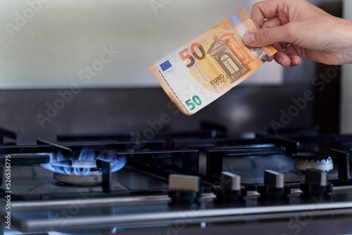 Natural Gas Crisis Inflation, 50 Euro Note is Burning on a stove fired by natural gas. 
