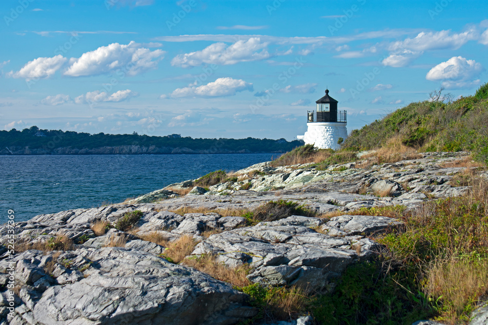 Castle Hill lighthouse in Newport, Rhode Island, overlooking Narragansett Bay from a rocky shoreline -12