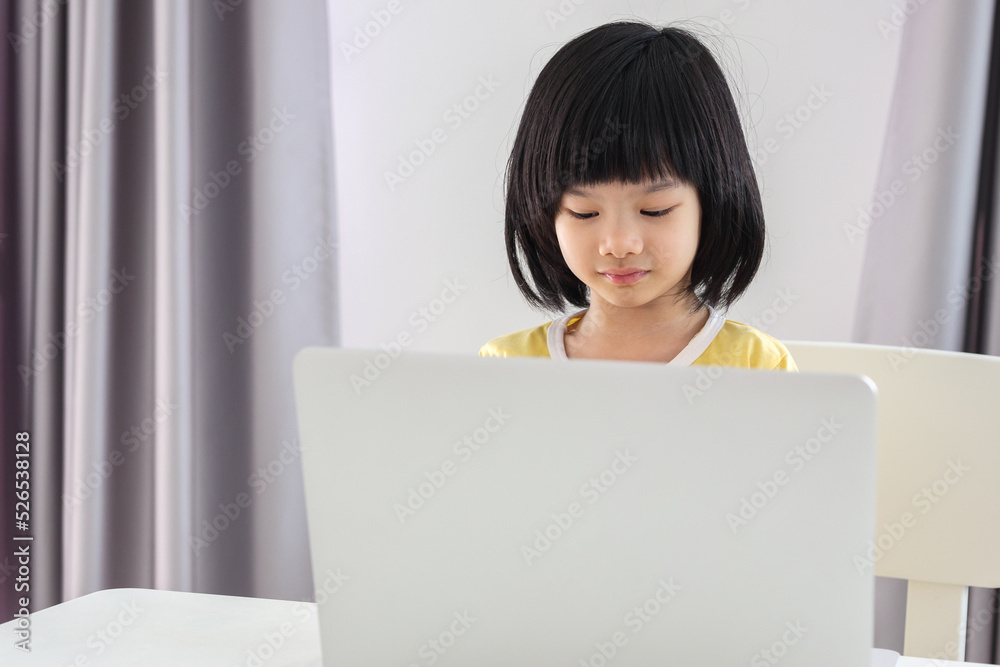 little asian girl student study online using laptop computer at home little asian girl student study online using laptop computer at home