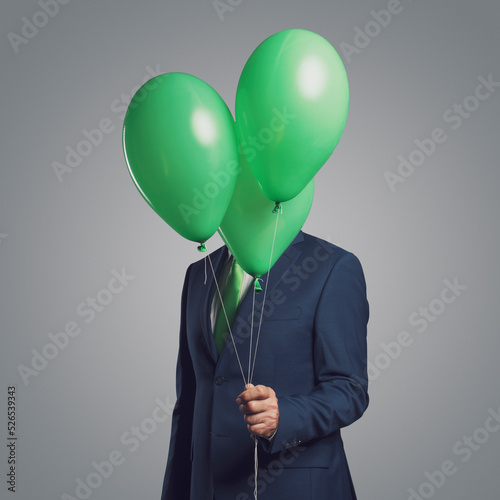 Canvas Print Businessman hiding behind balloons