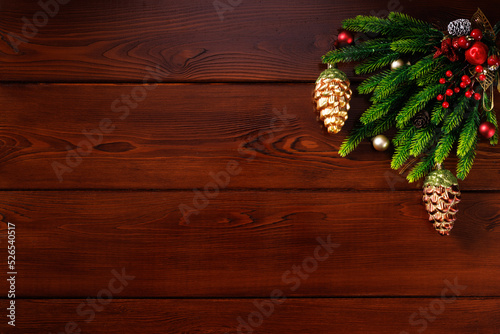Horizontal Christmas or New Year wooden background with decorations in the top corner, space for text, top view.