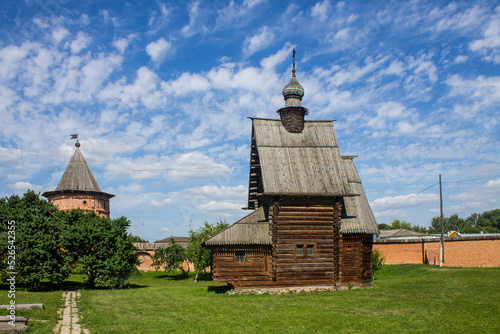 The courtyard of the Kremlin in Yuriev-Polsky in Russia with ancient architecture on bright green grass on a sunny summer day and a space for copying