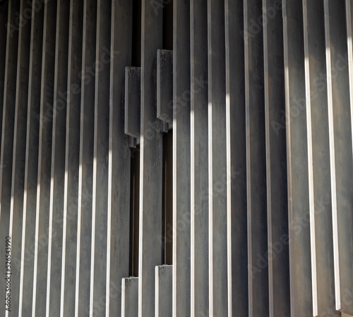 Gray and White Building Facade with Sunlight and Shadows.