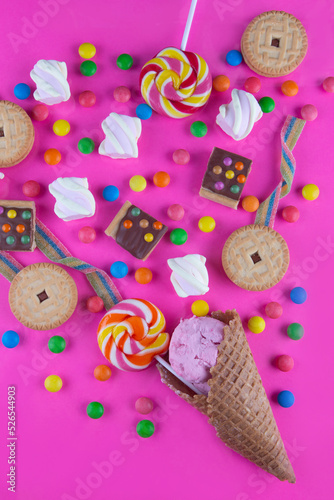 Photography Variety of different sweets, candies on bright magenta background
