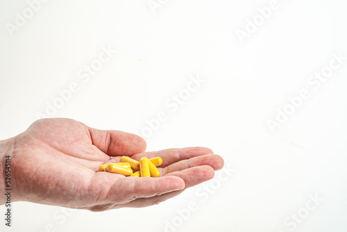 a handful of medicine in a man's hand