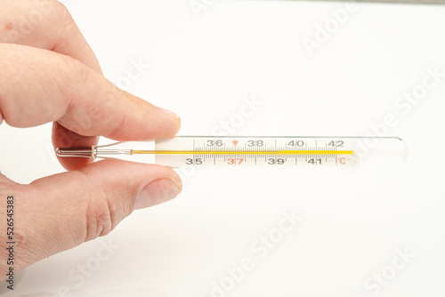 mercury thermometer in the man's left hand
