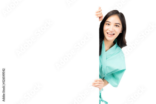 Excite asian woman hiding behind white wall with blank space isolated on white background Patient girl peeping out a side of white Advertising Board For Text Design or Advertisement Smiling Lady happy