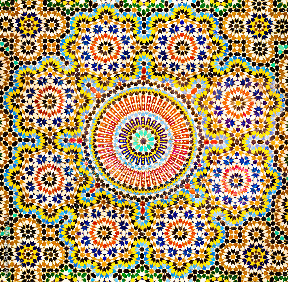Beautiful Islamic mosaic pattern in Moroccan style. Mosaic oriental ornaments can be found in mosques, important buildings and drinking fountains on the street. Fes, Morocco.