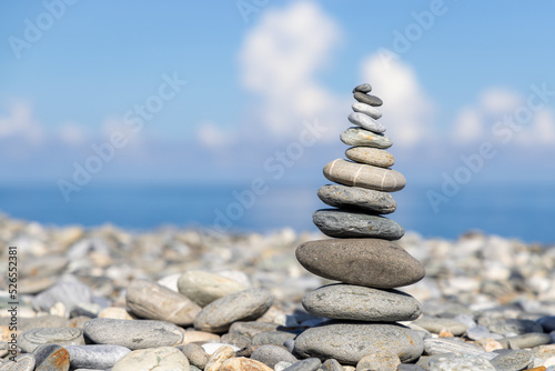 Pebble tower balance harmony stones arrangement on sea beach coastline