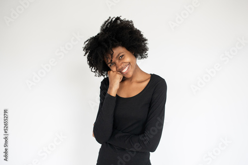 Portrait of cute young African American woman smiling. Happy young female model wearing black dress posing against white background. Female beauty concept © KAMPUS