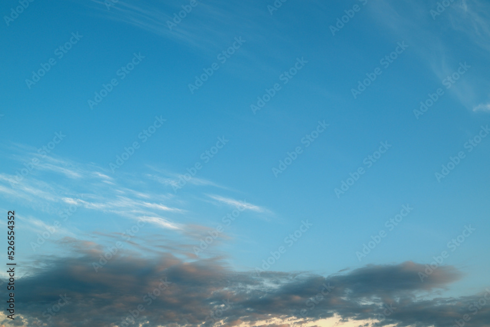 Background from the clouds at sunset or dawn with space for text. Blue clouds in sunset. Background from the clouds at sunset or dawn with space for text. Blue clouds in sunset.