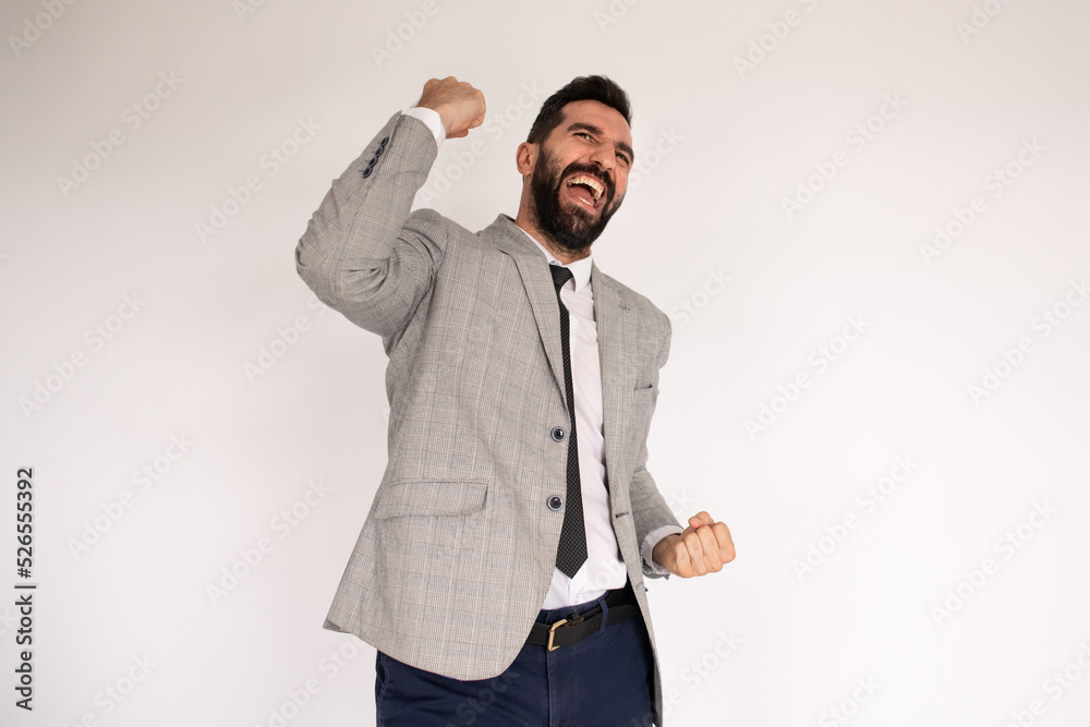 Blissful bearded man in studio. Male in suit gesturing and smiling happily. Portrait, emotion, achievement concept Blissful bearded man in studio. Male in suit gesturing and smiling happily. Portrait, emotion, achievement concept