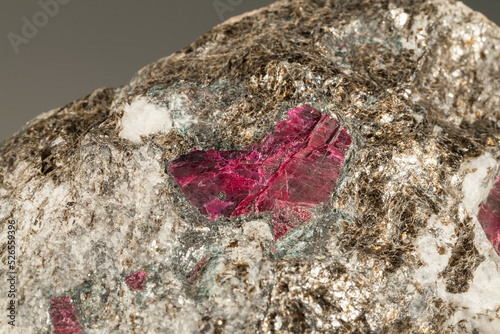 A sample of a natural mineral red Corundum (oxide class) crystalline α -aluminum oxide, crystals with albite rim in micite. Museum Mineral Series. Mineralogical sample