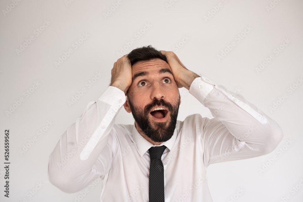 Portrait of surprised man with beard. Male in suit gesturing with surprise, looking up. Portrait, emotion concept Portrait of surprised man with beard. Male in suit gesturing with surprise, looking up. Portrait, emotion concept