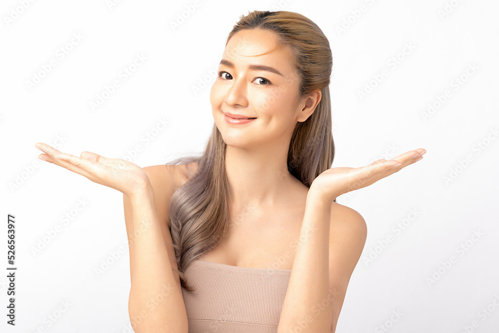 Happy beautiful asian woman looking to camera and showing empty copy space on the open hand. Asian girl beauty face skincare and health wellness, Facial treatment, Isolated on white background. Happy beautiful asian woman looking to camera and showing empty copy space on the open hand. Asian girl beauty face skincare and health wellness, Facial treatment, Isolated on white background.