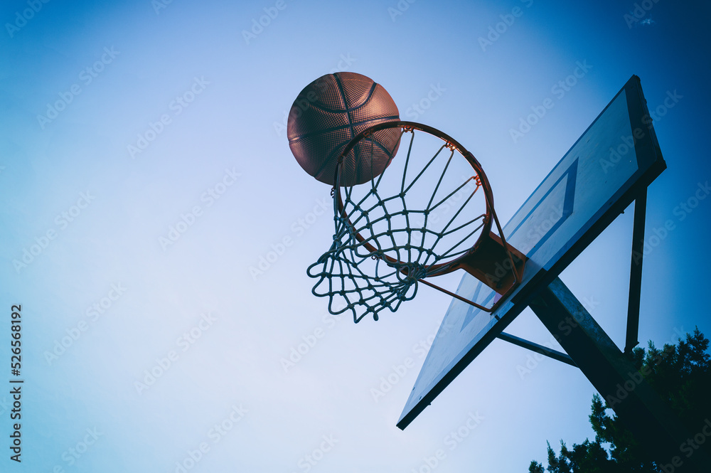 Ball enters the basket in an outdoor playing field