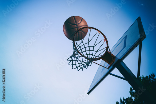 Ball enters the basket in an outdoor playing field © alphaspirit