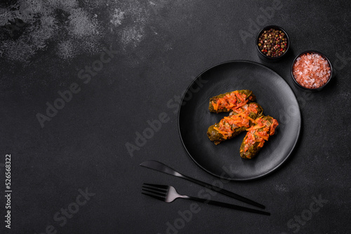Dolma, stuffed grape leaves with rice and meat on a dark background