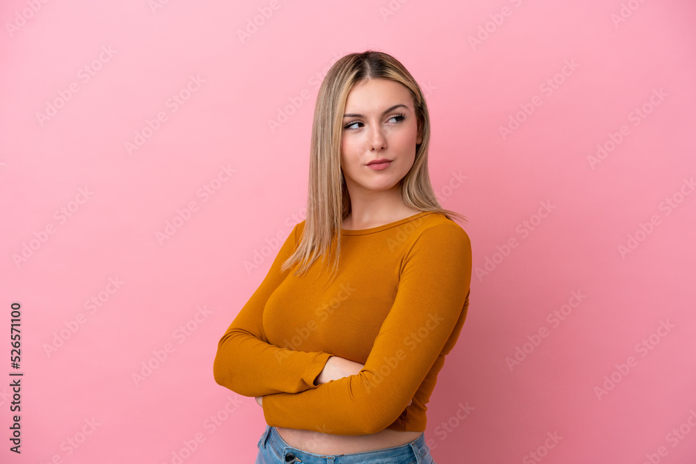 Young caucasian woman isolated on pink background keeping the arms crossed Young caucasian woman isolated on pink background keeping the arms crossed