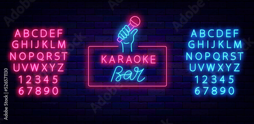 Karaoke bar neon label. Microphone in hand icon. Talent show. Shiny blue and pink alphabet. Vector stock illustration