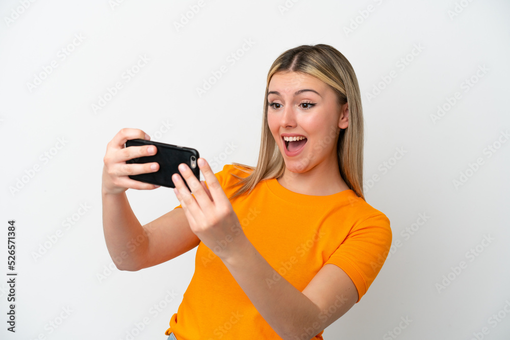 Young caucasian woman isolated on white background playing with the mobile phone Young caucasian woman isolated on white background playing with the mobile phone