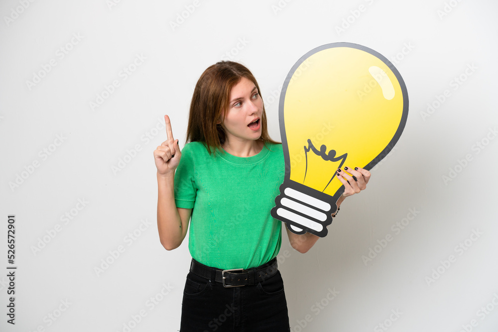 Young English woman isolated on white background holding a bulb icon and thinking Young English woman isolated on white background holding a bulb icon and thinking