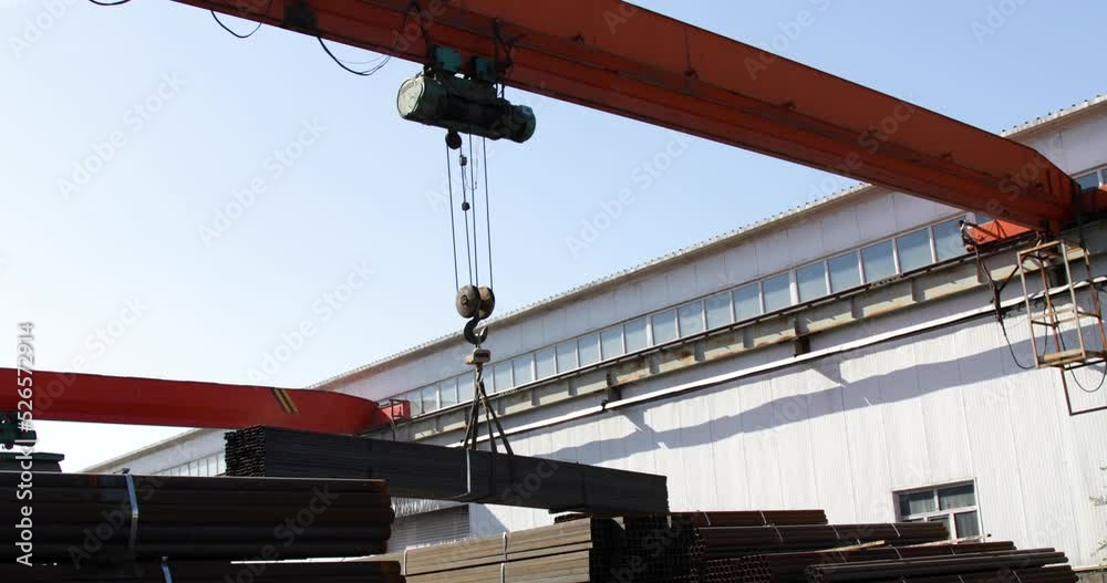 Gantry crane transporting stack of metal pipes Gantry crane transporting stack of metal pipes