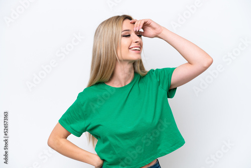 Pretty blonde woman isolated on white background smiling a lot