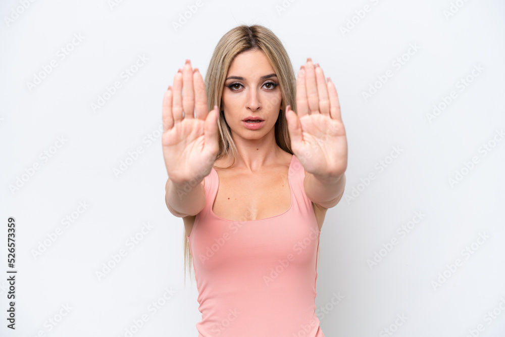 Pretty blonde woman isolated on white background making stop gesture and disappointed Pretty blonde woman isolated on white background making stop gesture and disappointed