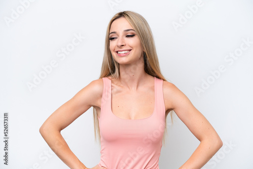 Pretty blonde woman isolated on white background posing with arms at hip and smiling
