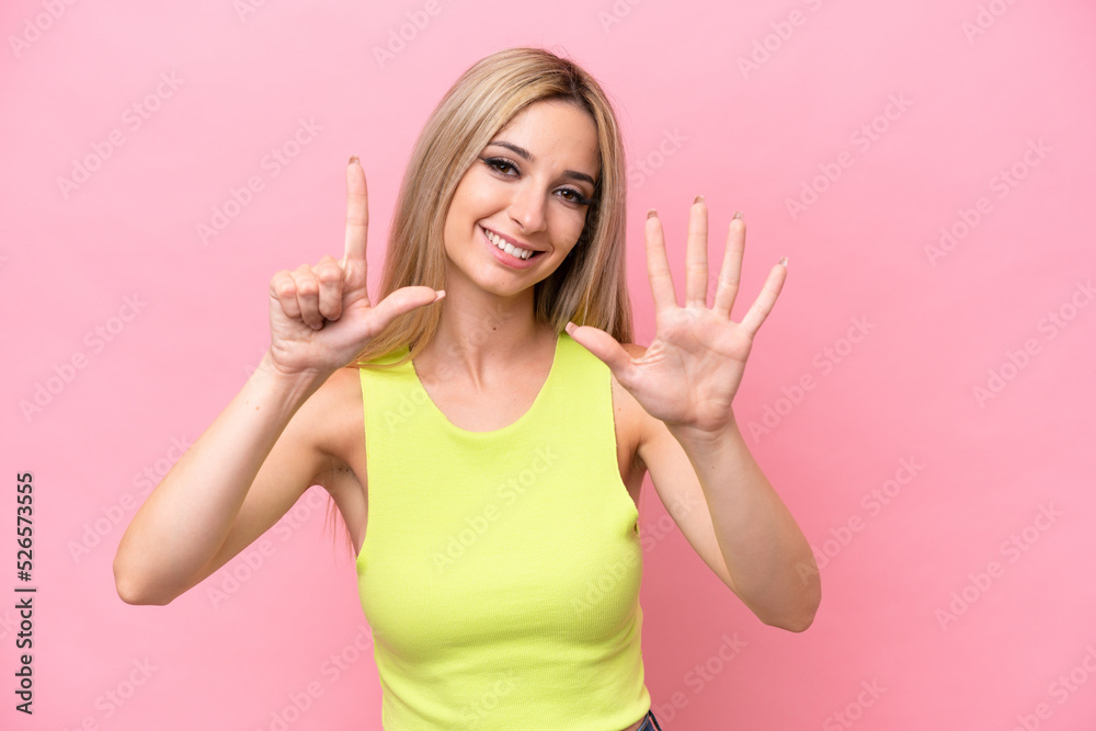 Pretty blonde woman isolated on pink background counting seven with fingers Pretty blonde woman isolated on pink background counting seven with fingers