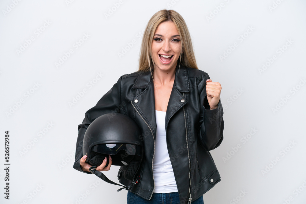 Pretty blonde woman with a motorcycle helmet isolated on white background celebrating a victory in winner position Pretty blonde woman with a motorcycle helmet isolated on white background celebrating a victory in winner position
