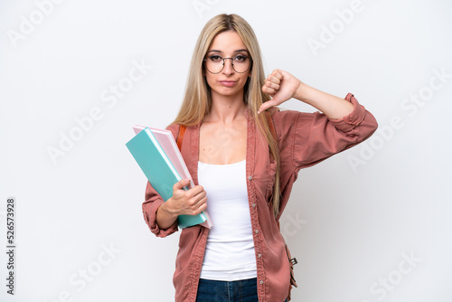 Pretty student blonde woman isolated on white background showing thumb down with negative expression