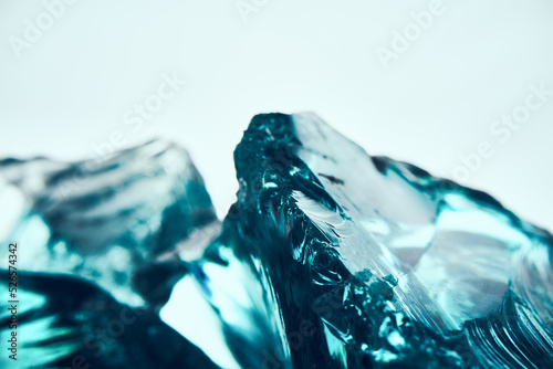 Obraz na plátně Texture of transparent blue glass on a light background.
