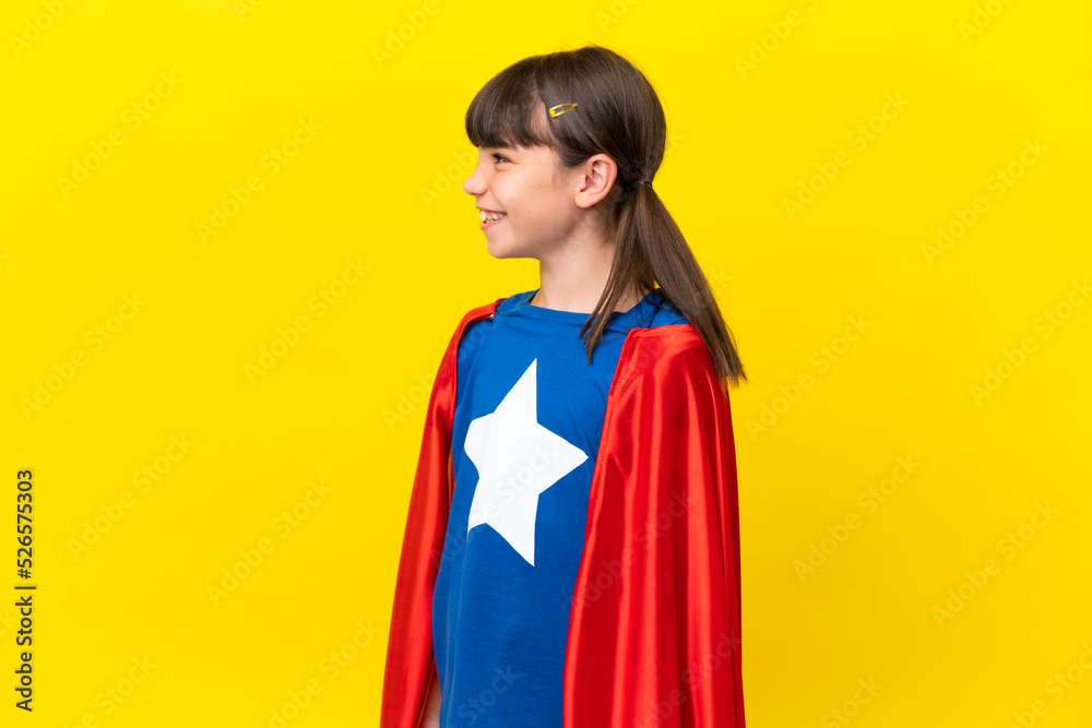 Little super hero kid isolated on purple background looking side Little super hero kid isolated on purple background looking side