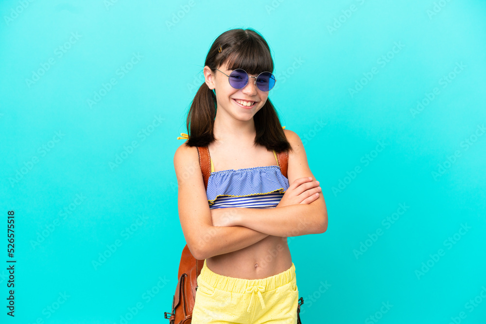 Little caucasian kid going to the beach isolated on blue background keeping the arms crossed in frontal position
