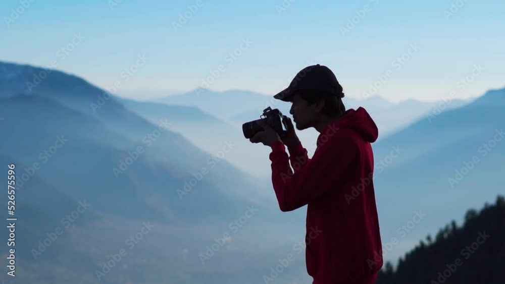 custom made wallpaper toronto digitalSilhouette shot of an Indian photographer taking photo in front of the foggy Himalayan mountains at Manali in Himachal Pradesh, India. Traveler taking photo of mountains. Man shoots landscape. 