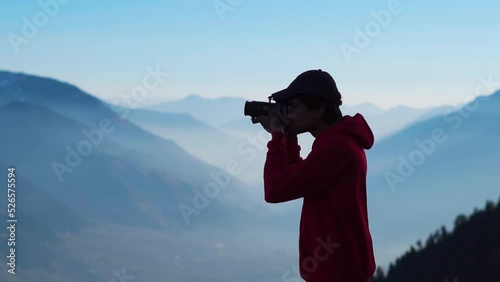 Wallpaper Mural Silhouette shot of an Indian photographer taking photo in front of the foggy Himalayan mountains at Manali in Himachal Pradesh, India. Traveler taking photo of mountains. Man shoots landscape. Torontodigital.ca