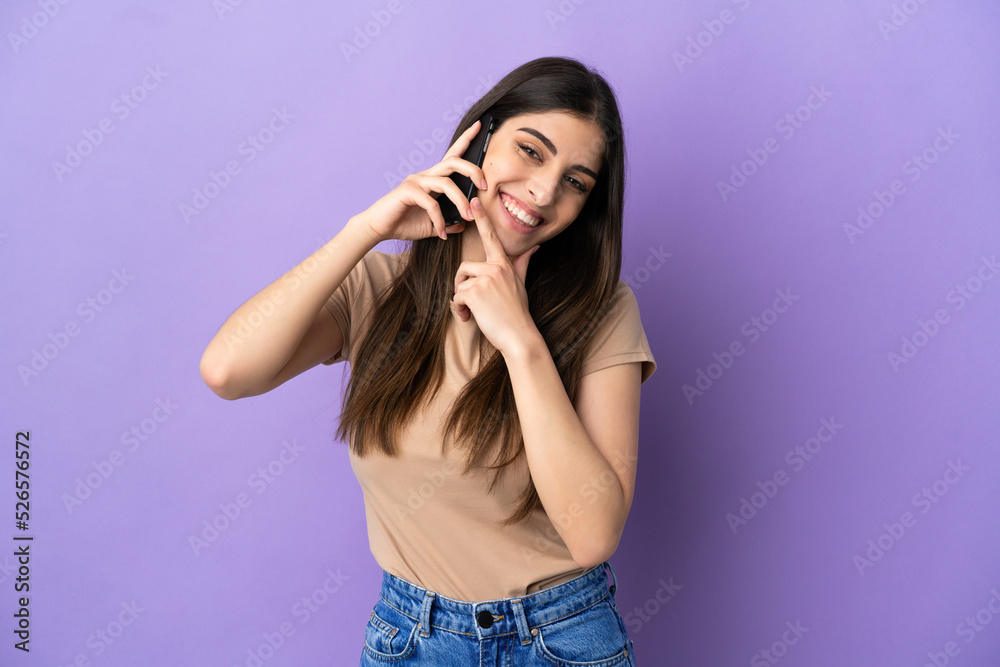 Young caucasian woman using mobile phone isolated on purple background happy and smiling Young caucasian woman using mobile phone isolated on purple background happy and smiling