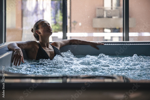 A young woman is relaxing in a jacuzzi. photo