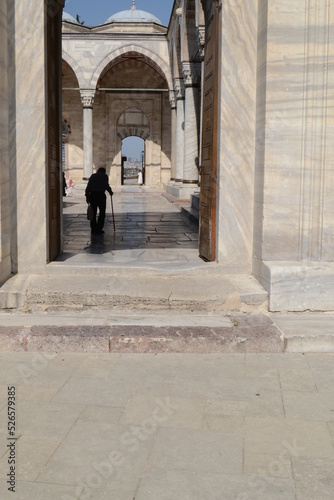 person walking in front of the mosque