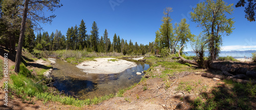 Panoramic View of River near the Lake surrounded by Mountains and Trees. Summer Season. Sugar Pine Point Beach, Tahoma, California, United States. Sugar Pine Point State Park. Nature Background. photo